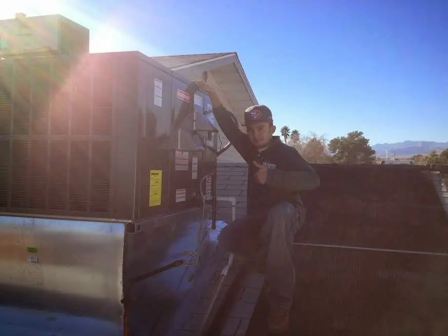 HVAC technician performing HVAC Inspection on a rooftop unit in Larkspur